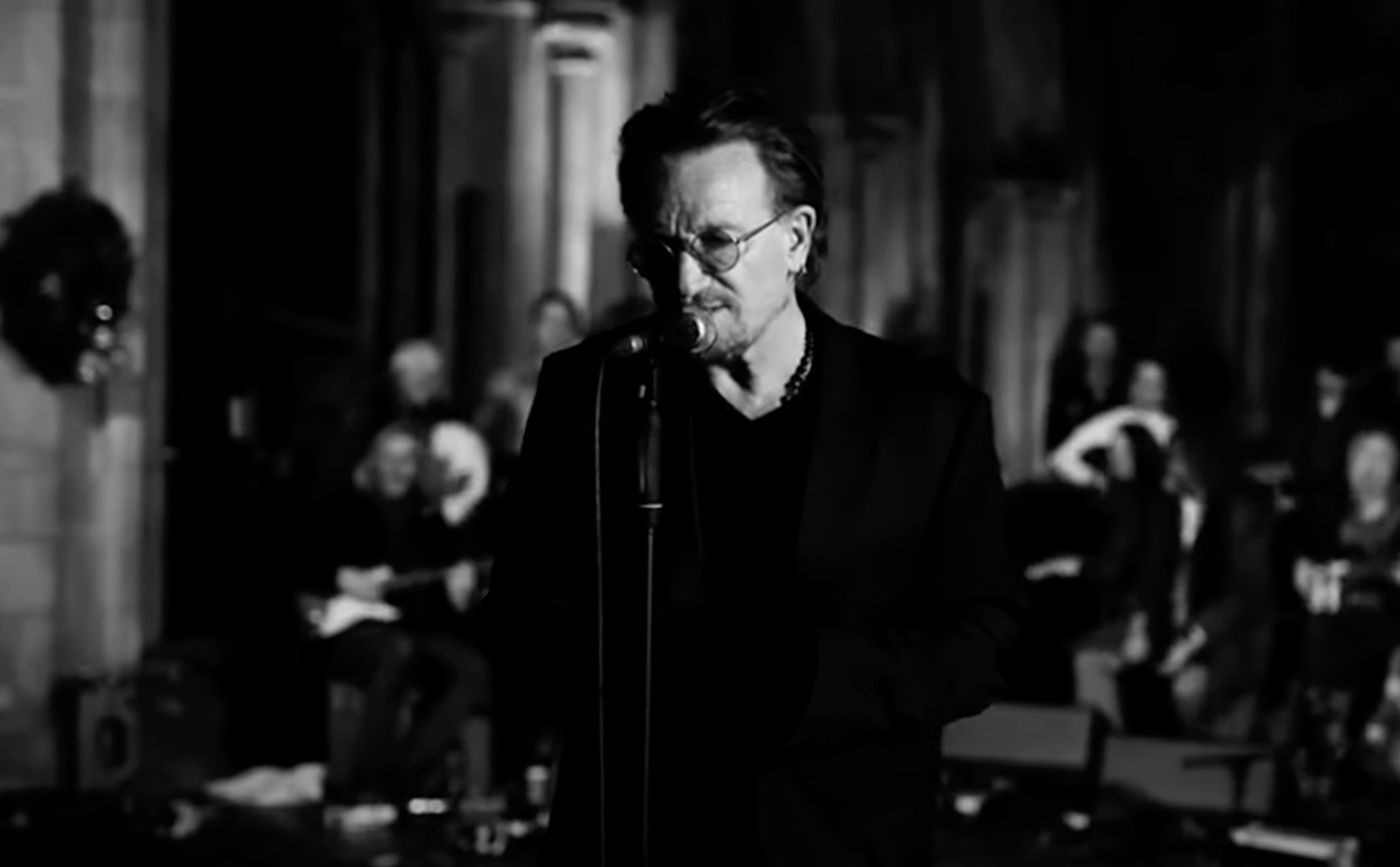U2's Bono standing beside a microphone at St Patrick's Cathedral in Dublin in Black and White